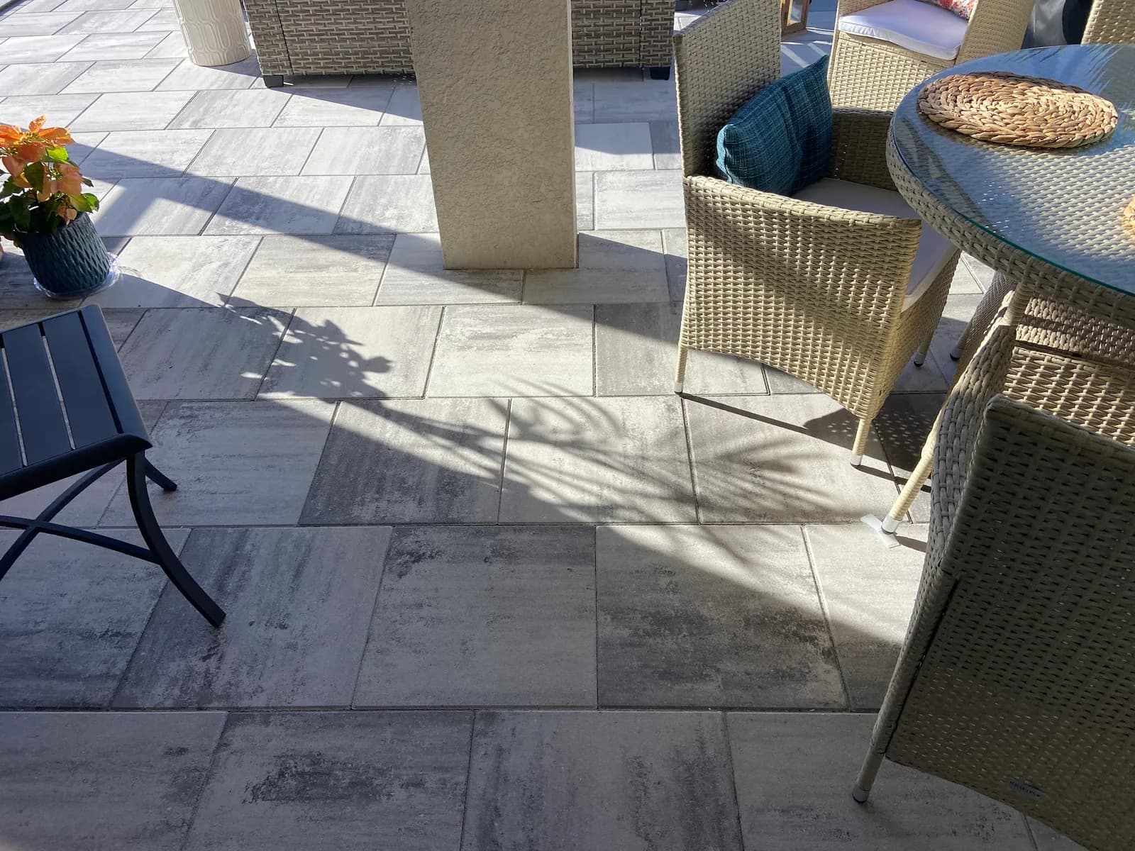 Paver patio with outdoor furniture and potted flowers in Osprey, FL